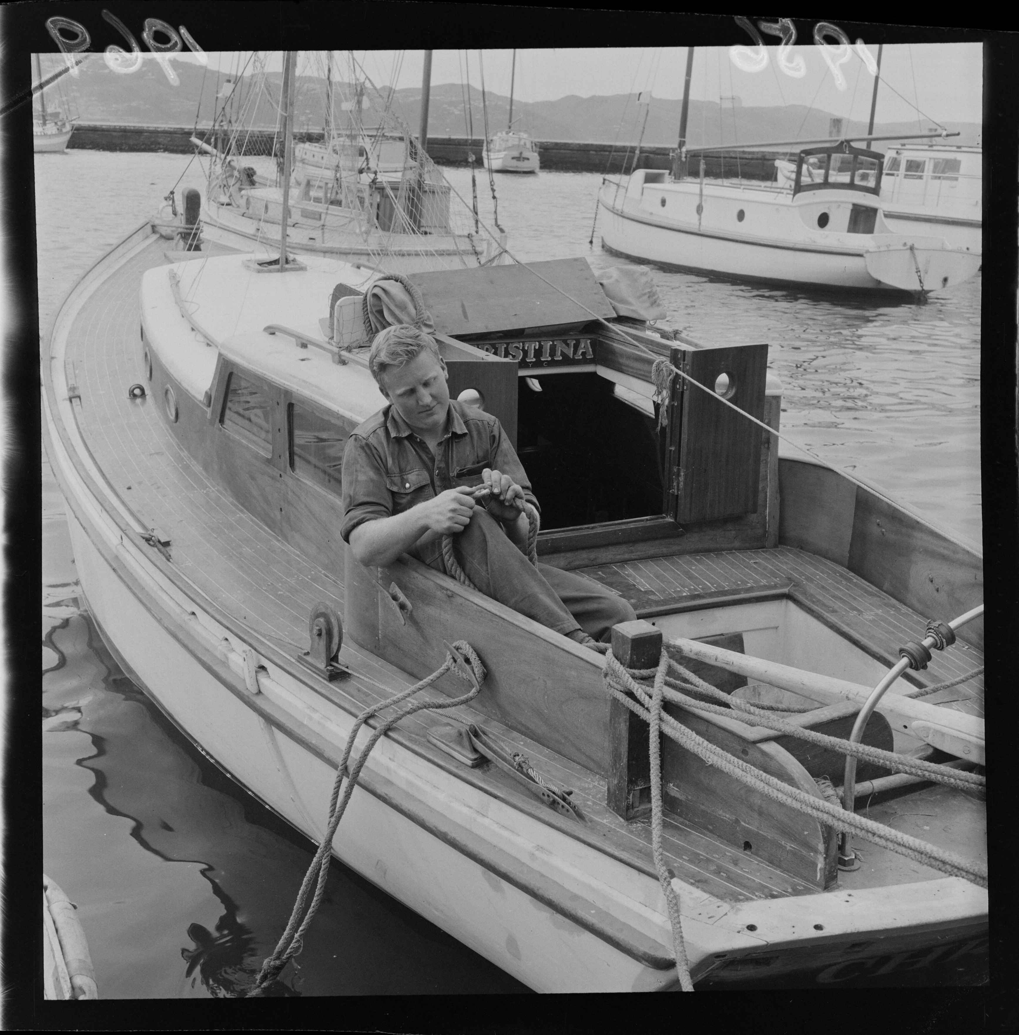 Mr W MacQueen on his yacht Christina 1956